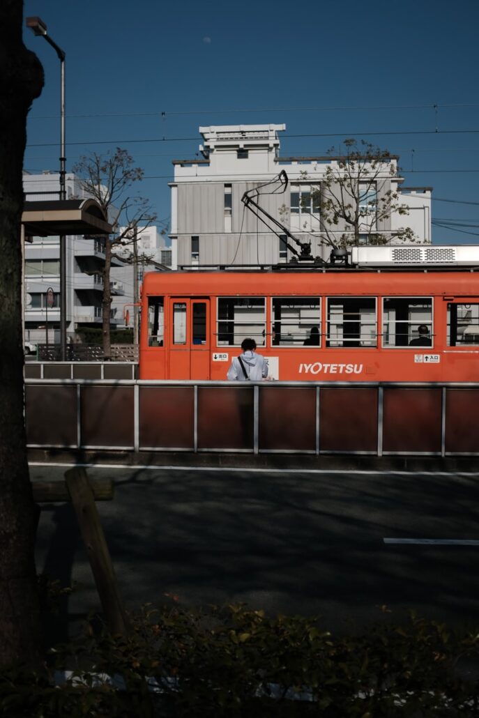 red and white train on rail road during daytime